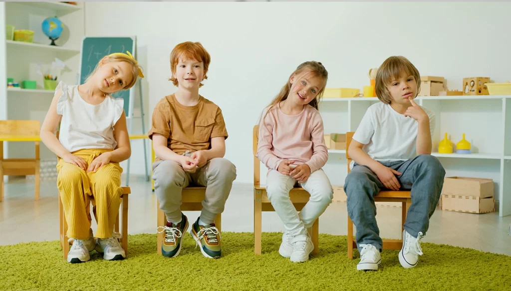 Children sitting on a chair smiling