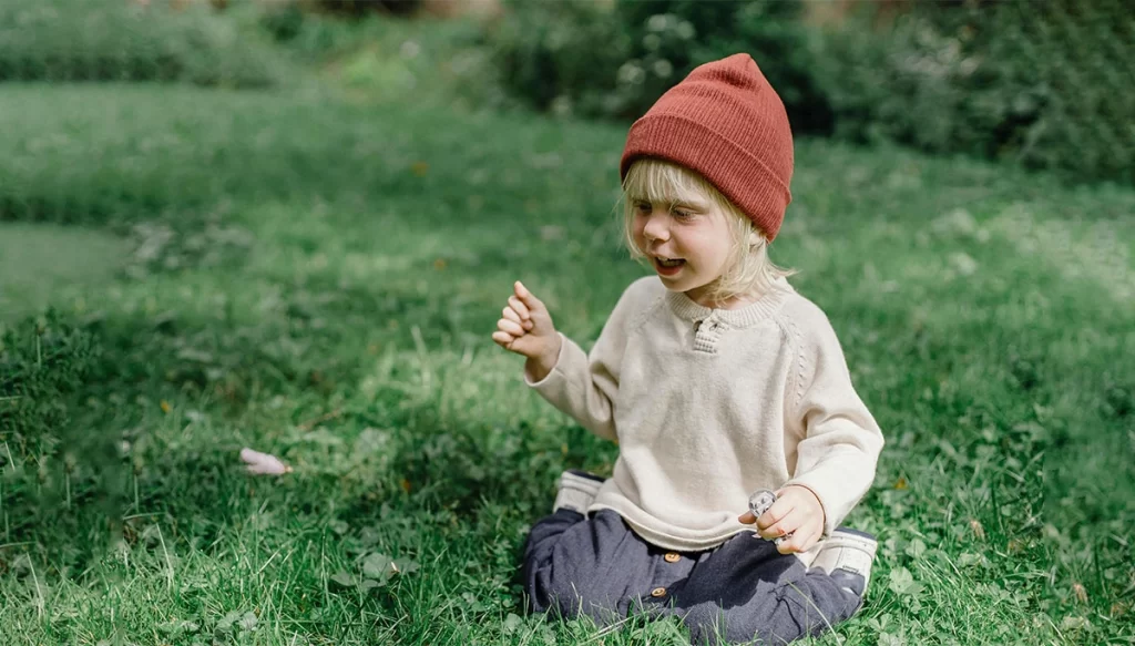 young boy playing on the grass