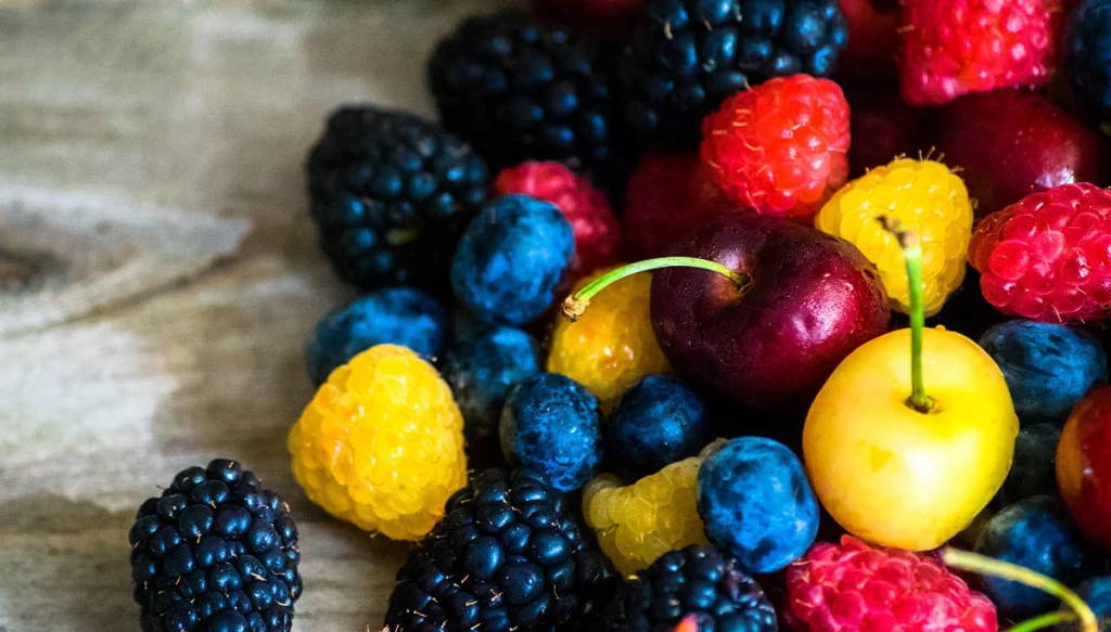 a collection of berries and cherries