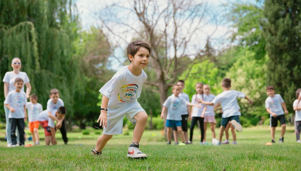 Group of children enjoying outdoor playtime in a green park during summer