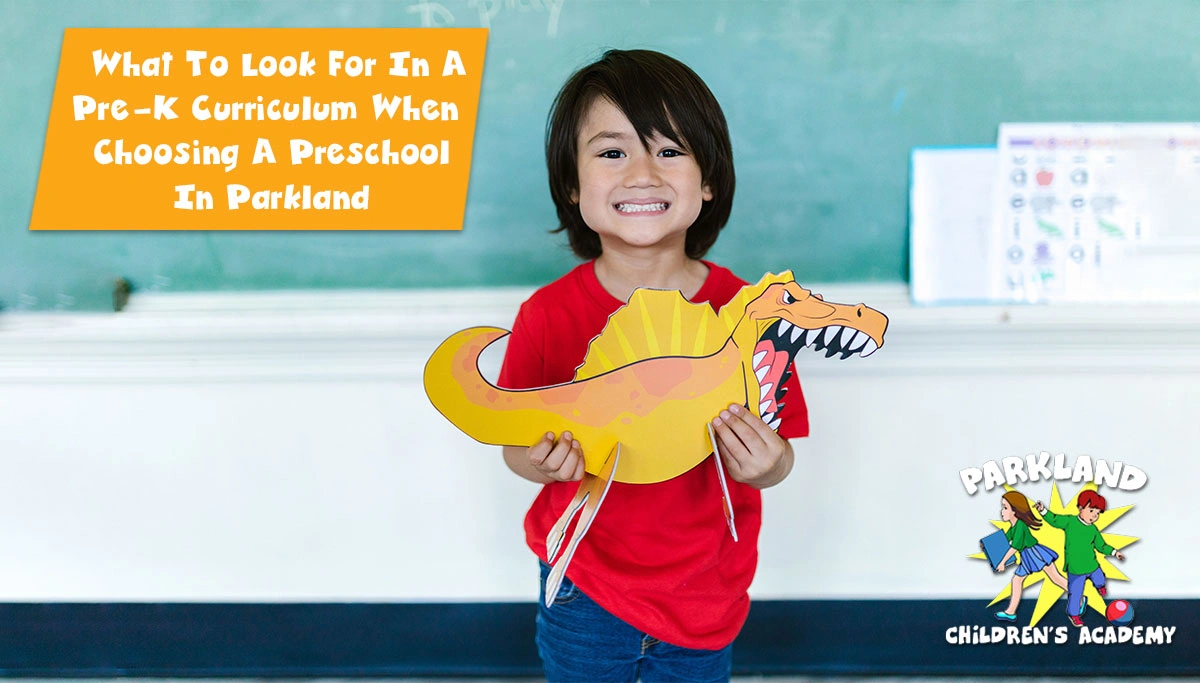 Young boy in a classroom playing with a dinosaur toy, highlighting learning fun.