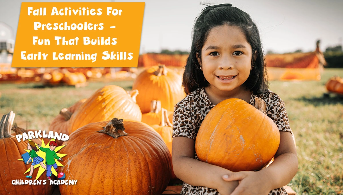 young girl sitting in a pumpkin patch holding a pumpkin